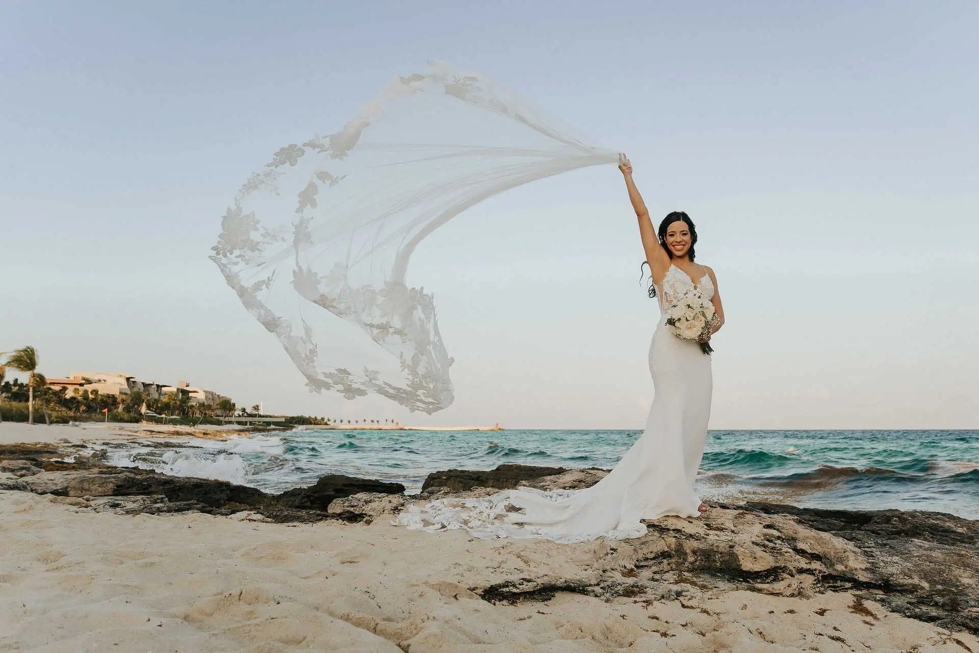 Julie Roman Photo woman wearing a wedding dress in Mexico on the beach of Hotel Xcaret for Yellow Umbrella Events