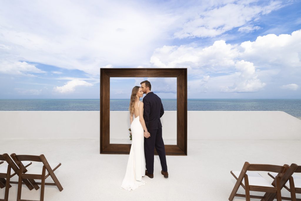 AVA Hotel wedding photo with bride and groom by yellow umbrella events