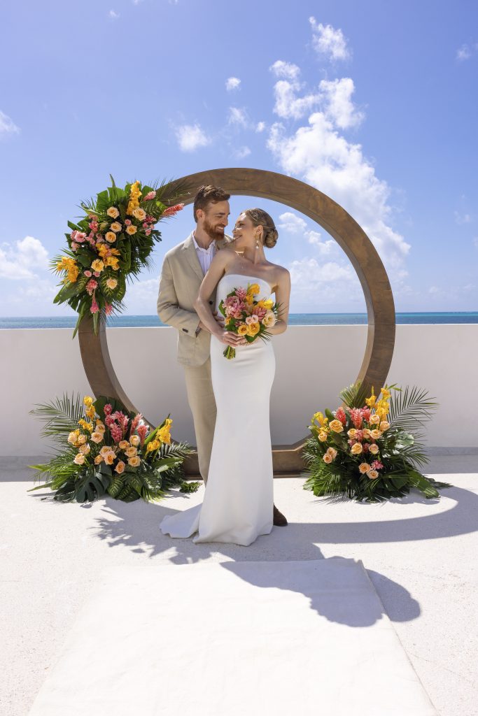 AVA Hotel wedding photo with bride and groom by yellow umbrella events